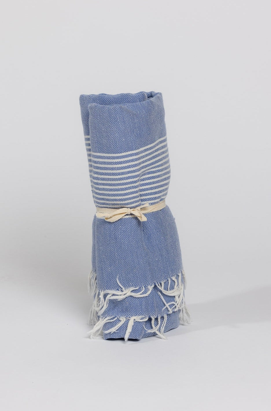   a blue Velvet by Graham & Spencer turkish towel on a white background. 