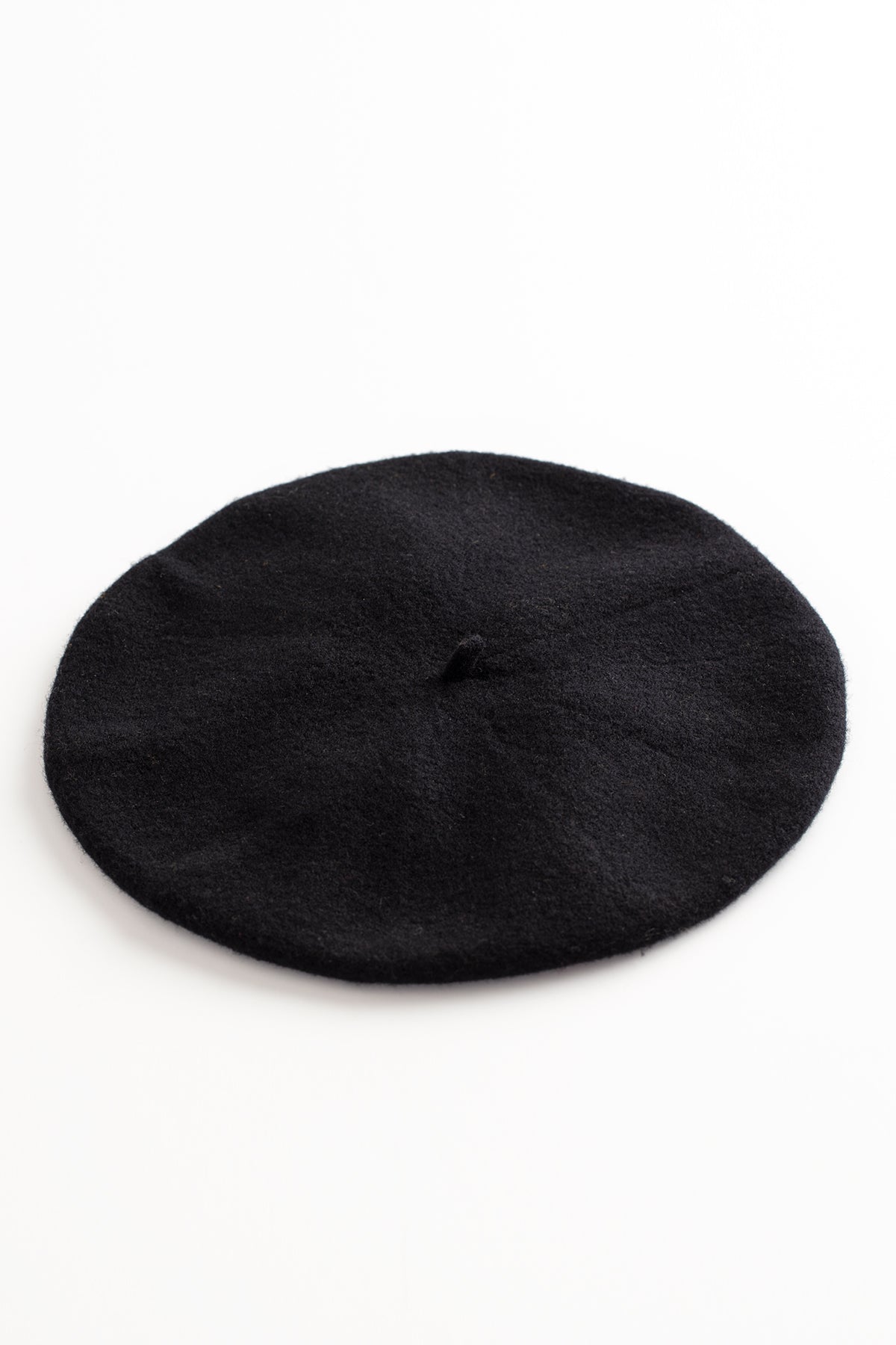 A black Gigi Beret by Hansel from Basel, made of a cozy Merino wool blend, resting on a clean white surface.-615332610129