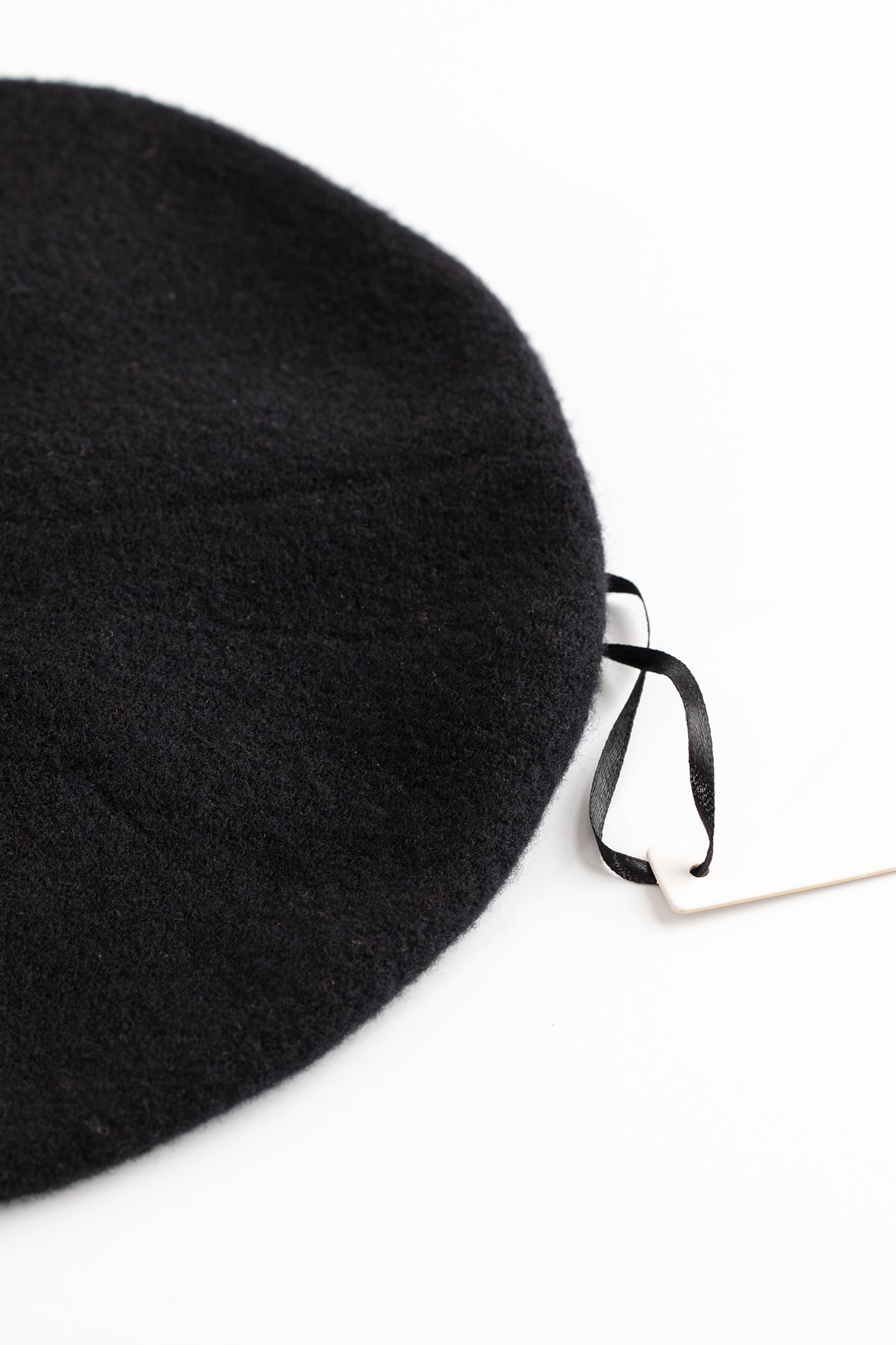 A Gigi beret made from a luxurious merino wool blend, with a stylish tag bearing the name "Hansel from Basel".-616317059153