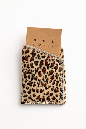 A SOFT LEATHER CARD HOLDER BY LIMA SAGRADA with a note inside, created by local artisans.