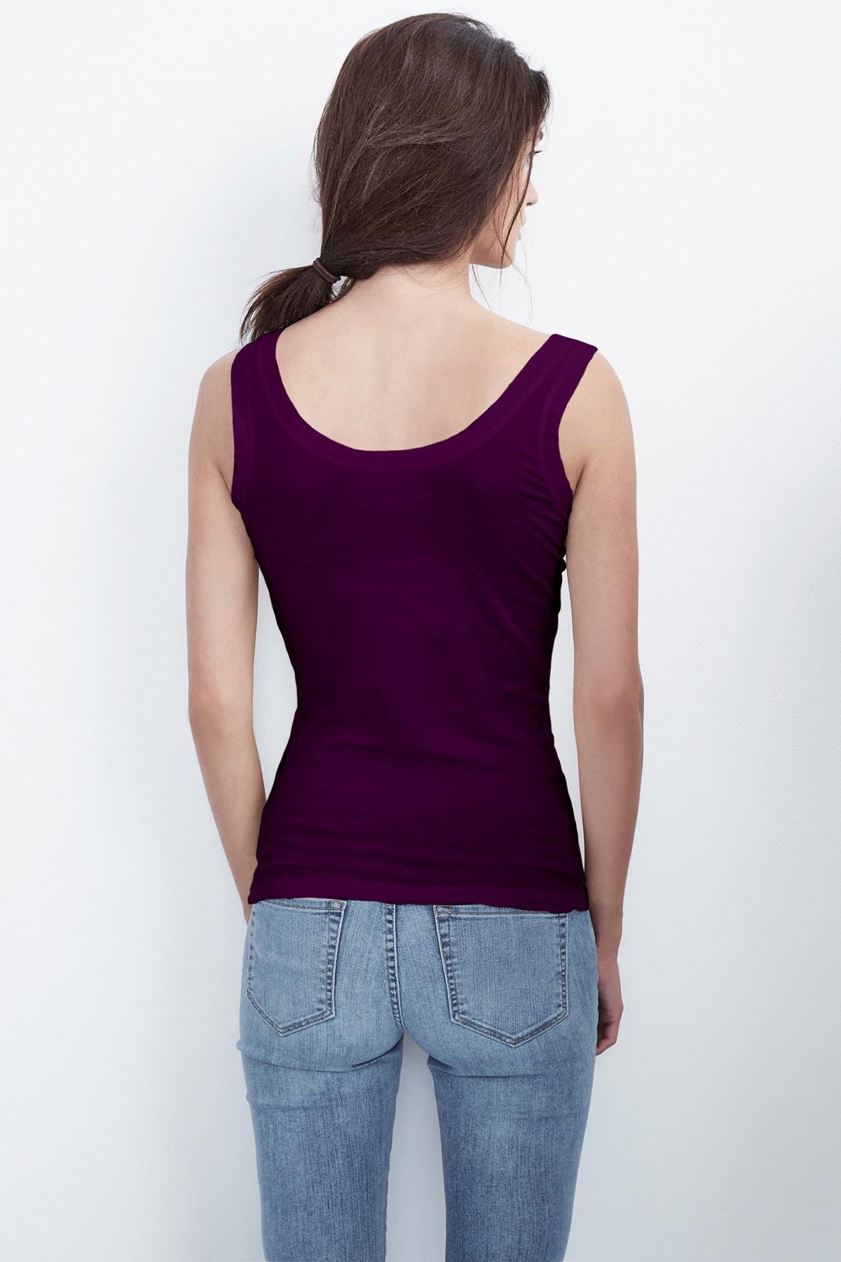   Back view of a woman wearing a MOSSY GAUZY WHISPER FITTED TANK in purple by Velvet by Graham & Spencer. 