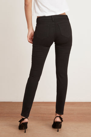 The back view of a classic woman wearing Velvet by Graham & Spencer's TONI SKINNY JEAN.