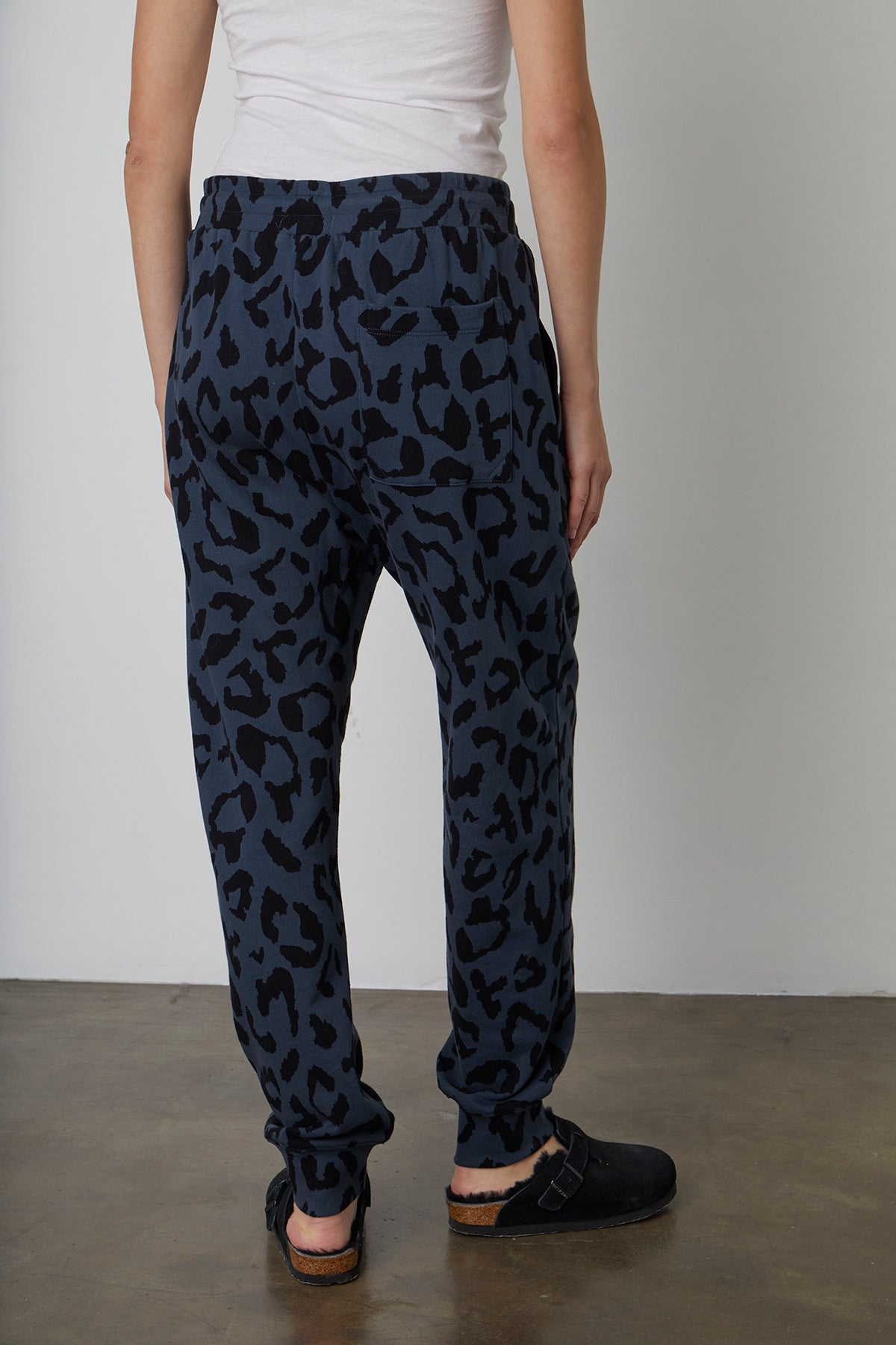   The back view of a woman sporting a bold GWEN PRINTED JOGGER pant by Velvet by Graham & Spencer. 