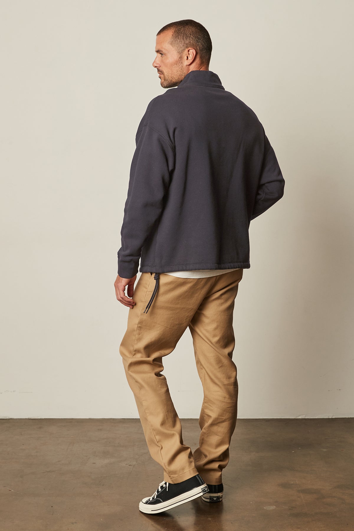   Baldwin Quarter-Zip Sweatshirt in ink front with khaki Aiden pants and Converse full length back 