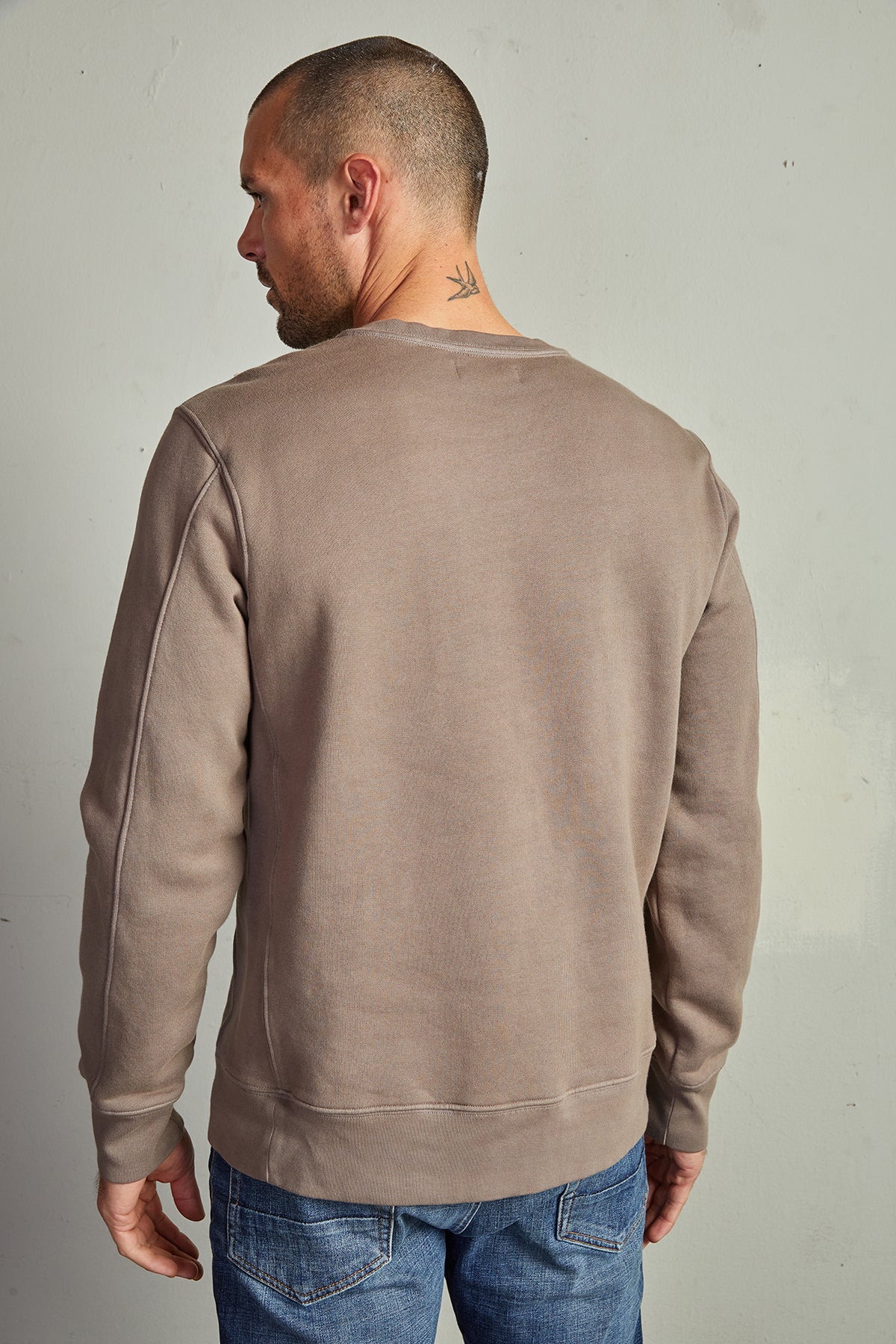The back view of a man wearing a Velvet by Graham & Spencer KING CREW NECK SWEATSHIRT with clean lines.-14889960571073