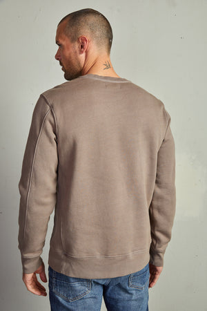 The back view of a man wearing a Velvet by Graham & Spencer KING CREW NECK SWEATSHIRT with clean lines.