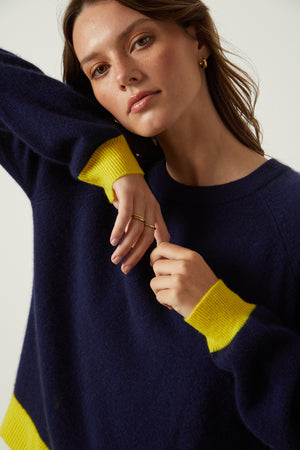 Claire Sweater in navy with yellow contrast at the cuffs and hemline close up detail accentuating sleeve detail
