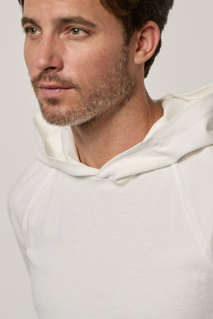 A man sporting a casual slouch in a Velvet by Graham & Spencer GREG HOODIE.