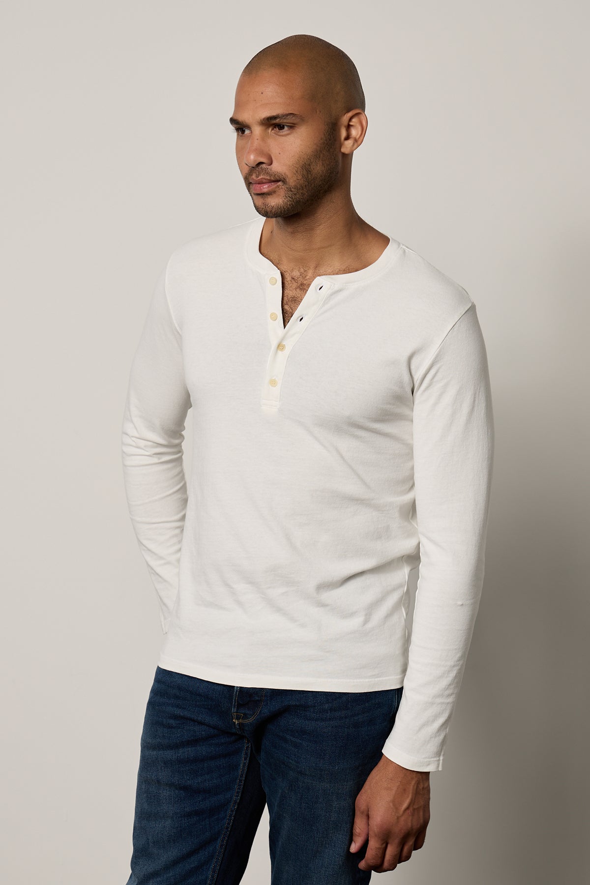   a man wearing jeans and a Velvet by Graham & Spencer BRAD HENLEY t-shirt. 
