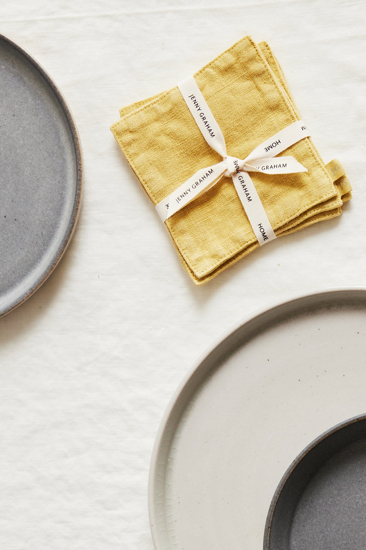   A set of Jenny Graham Home linen coasters (set of 4) on a white surface. 