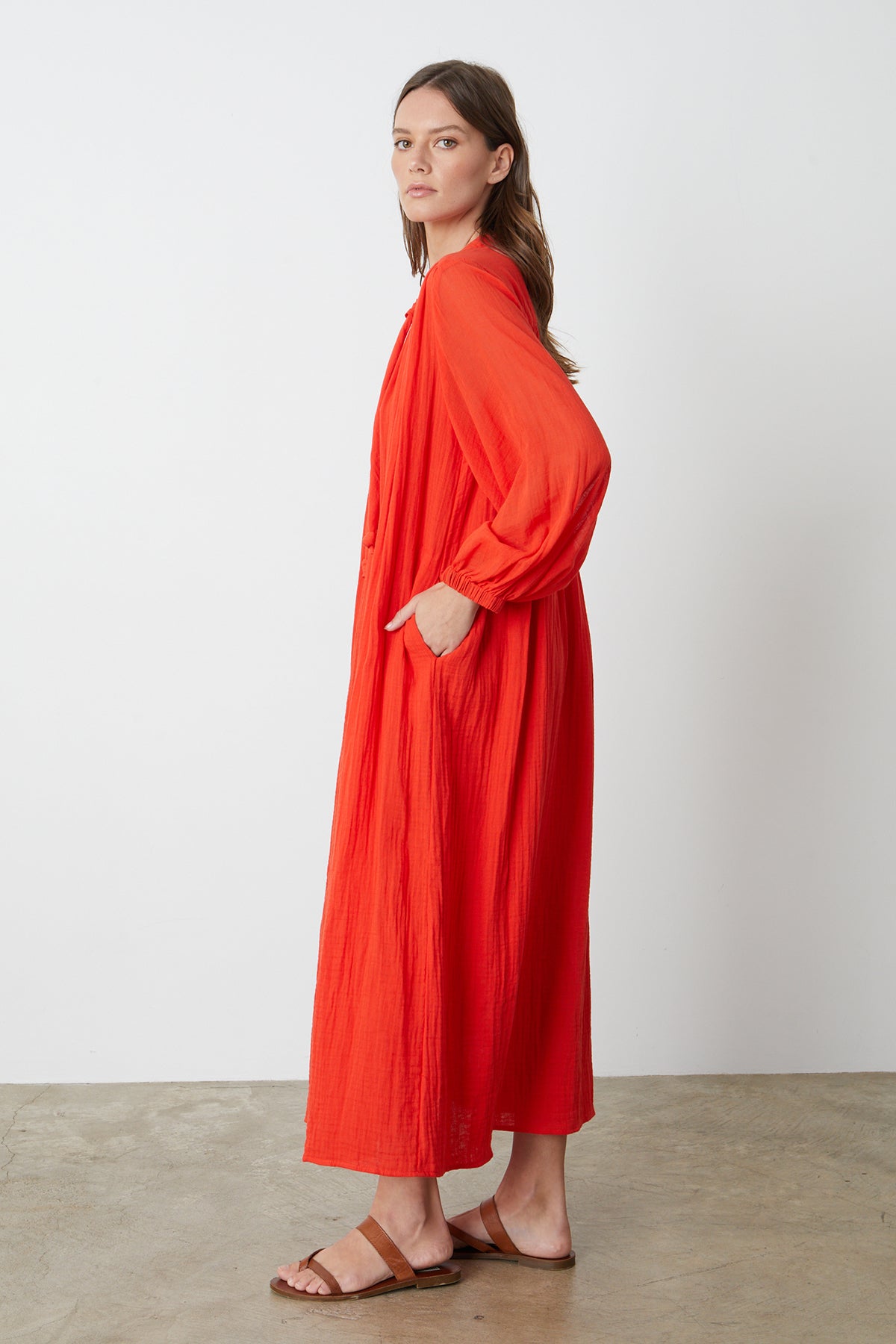 Carmella Maxi Dress in bright red cardinal color gauze model standing to the side with hand in pocket-26255708356801