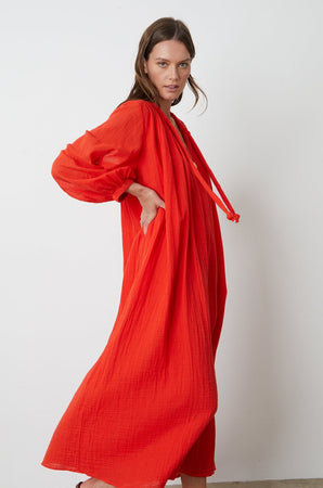 Carmella Maxi Dress in bright red cardinal color gauze model standing to the side with hand on hips