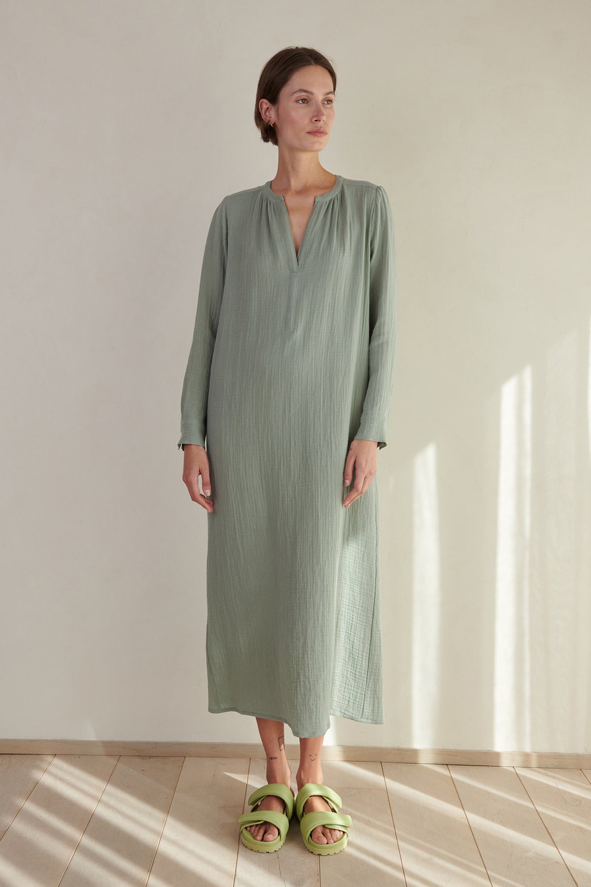 A woman wearing the DOHENY DRESS by Velvet by Jenny Graham and green sandals.-26293212905665