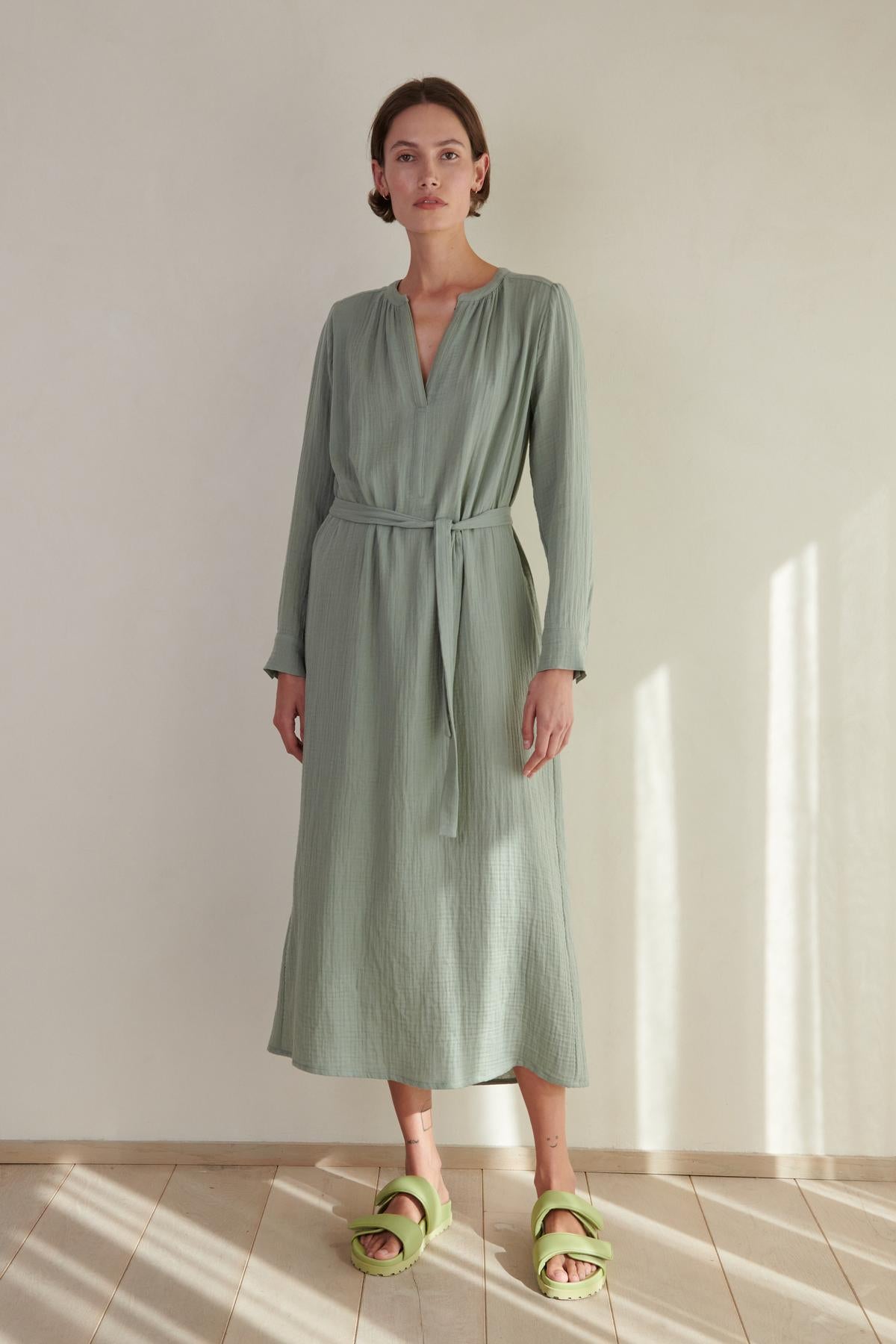A woman wearing a Velvet by Jenny Graham DOHENY DRESS and green sandals.-26293207728321