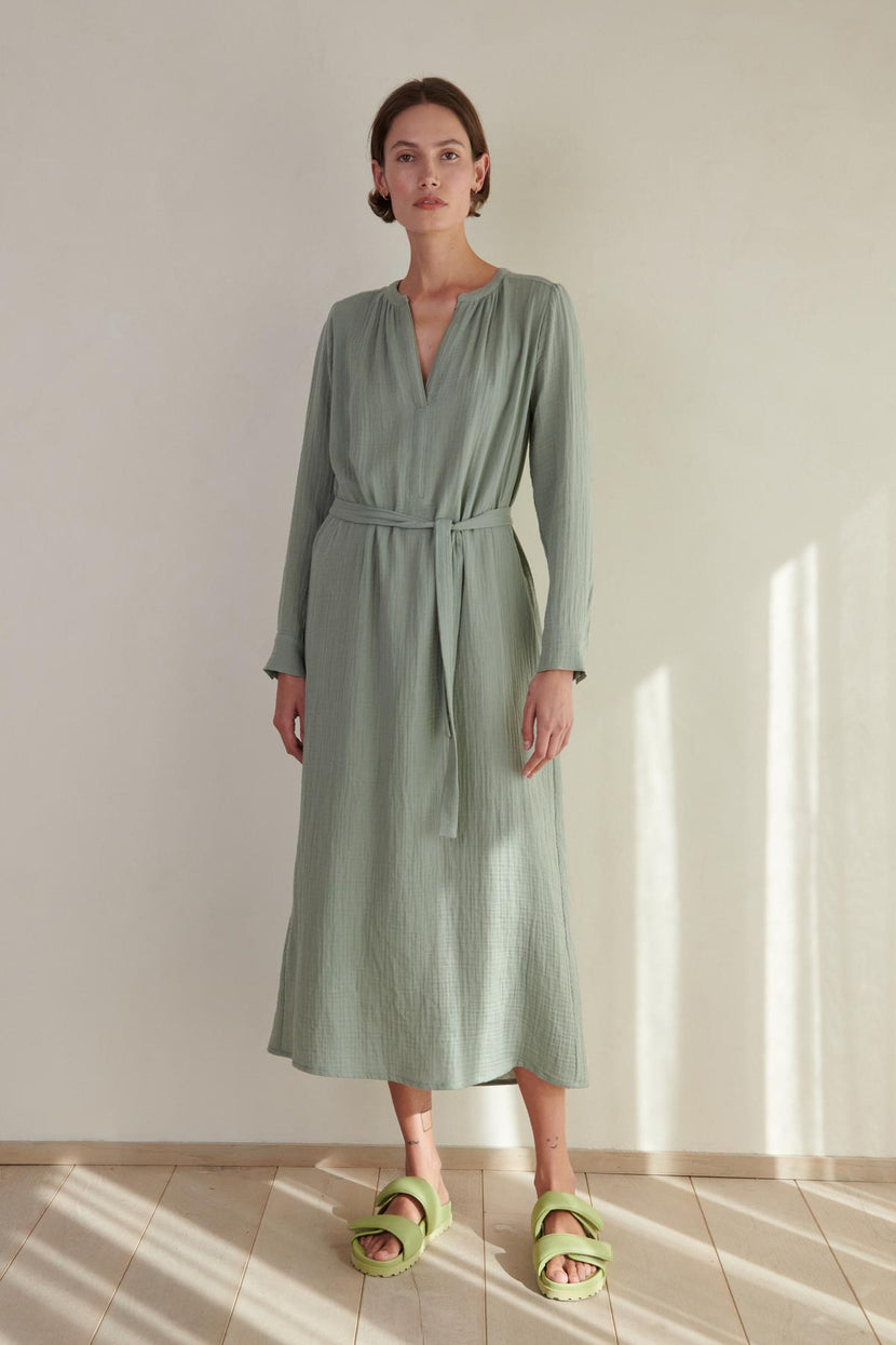 A woman wearing a Velvet by Jenny Graham DOHENY DRESS and green sandals.