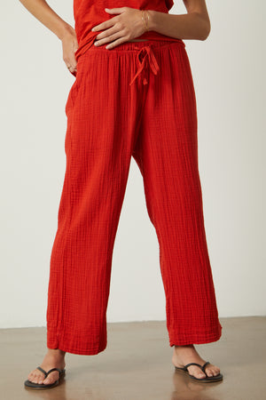 A woman wearing Velvet by Graham & Spencer FRANNY COTTON GAUZE PANT and sandals.