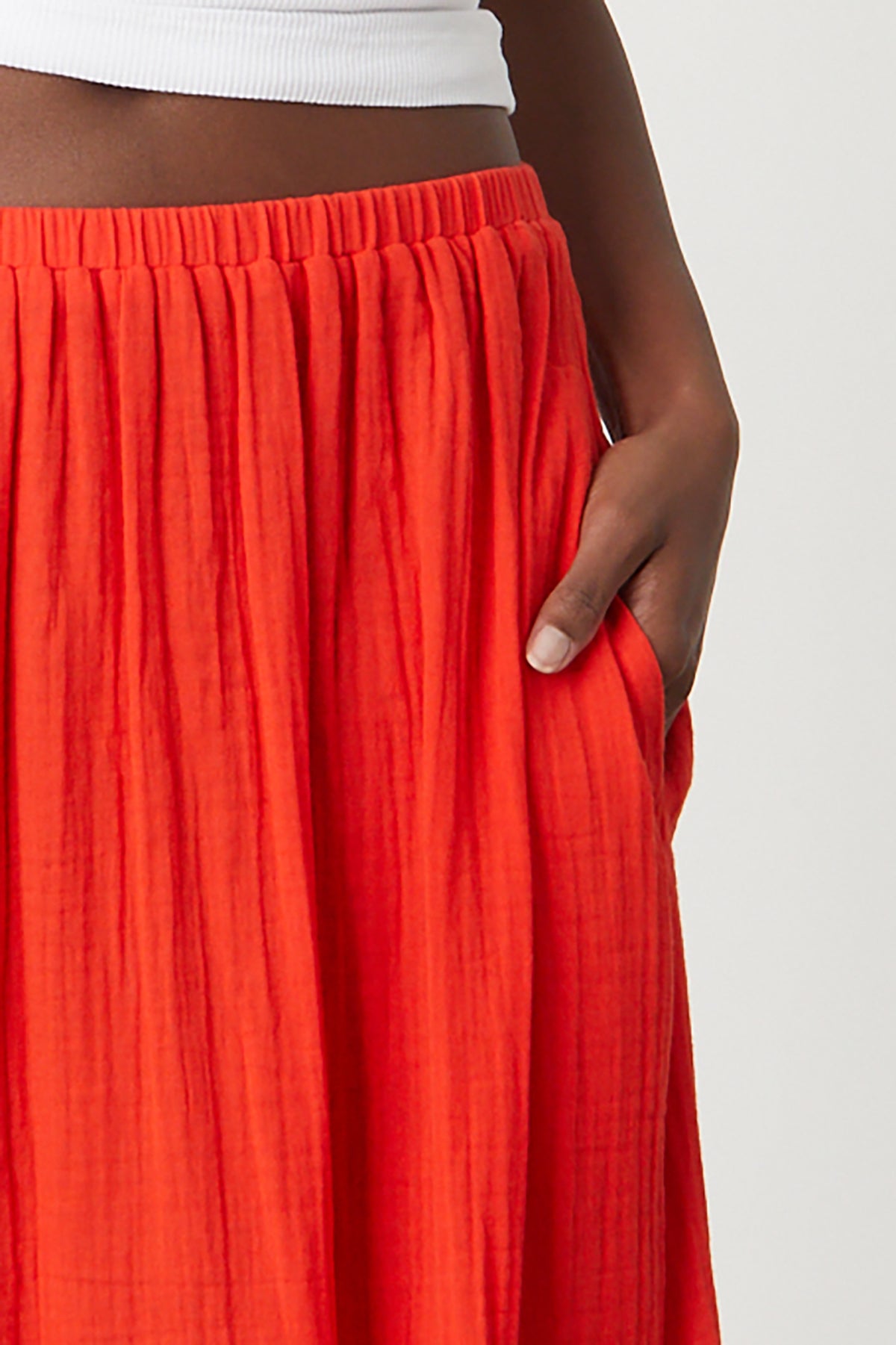 Mckenna Tiered Skirt in bright cardinal red close up front detail with model's hand in pocket-26255713566913