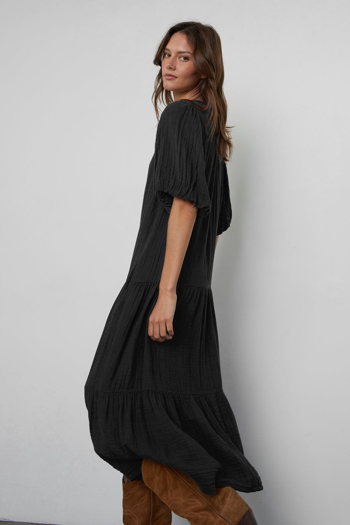   Pauline Cotton Gauze Midi Dress in Black side view with brown boots 
