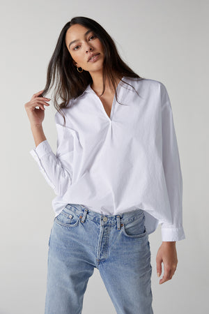 Velvet by Jenny Graham Brea Cotton Shirt in White Tucked Into Blue Denim With Gold Hoop Earrings Front