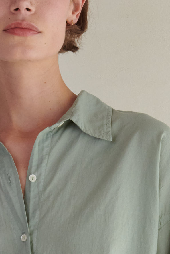   a woman wearing a REDONDO BUTTON-UP SHIRT in sage green by Velvet by Jenny Graham. 