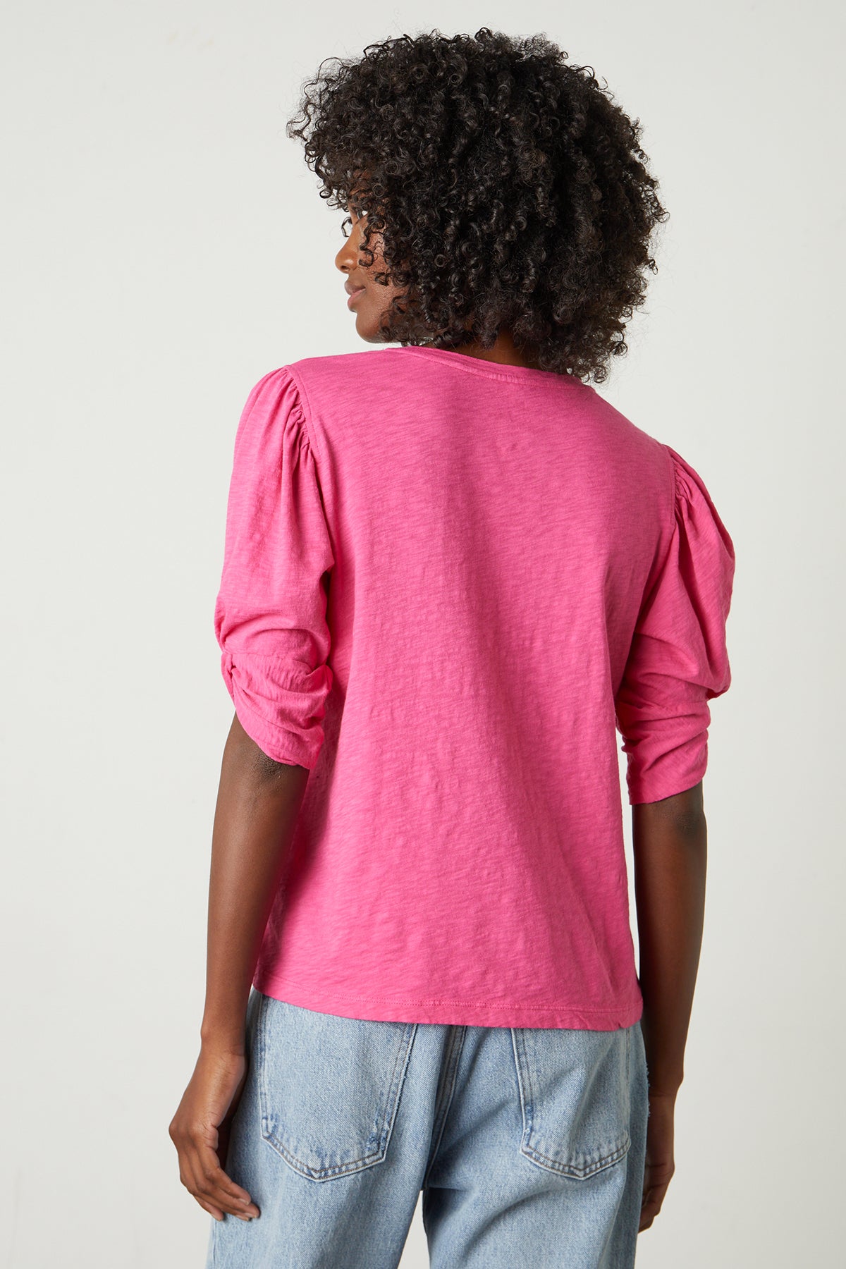 the back view of a woman wearing an AMELIA PUFF SLEEVE TEE by Velvet by Graham & Spencer.-25870884208833