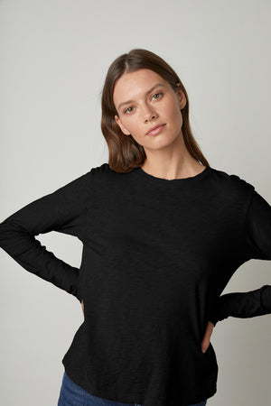 The model is wearing a Velvet by Graham & Spencer HESTER CREW NECK TEE.
