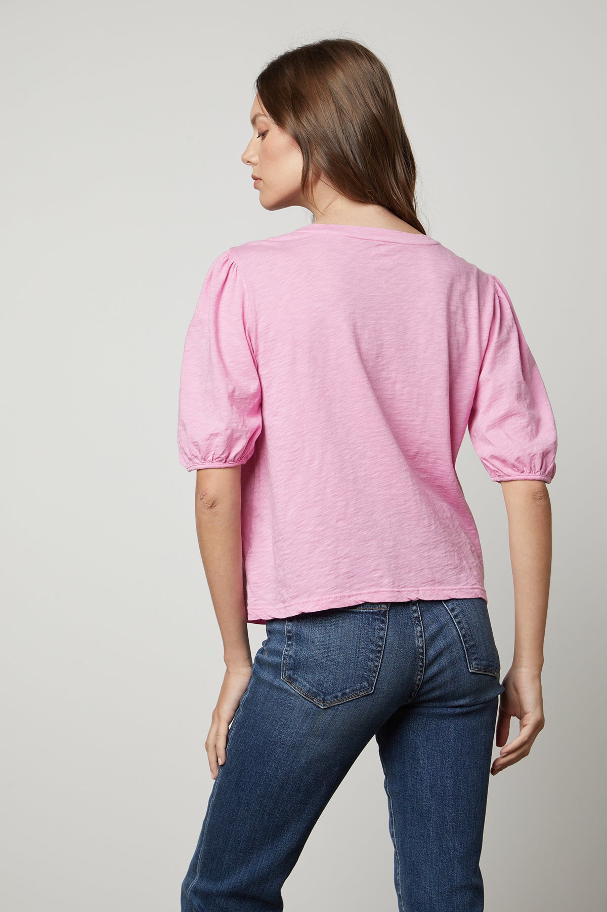 the back view of a woman wearing a Velvet by Graham & Spencer JOELLA PUFF SLEEVE TEE.-25954591310017