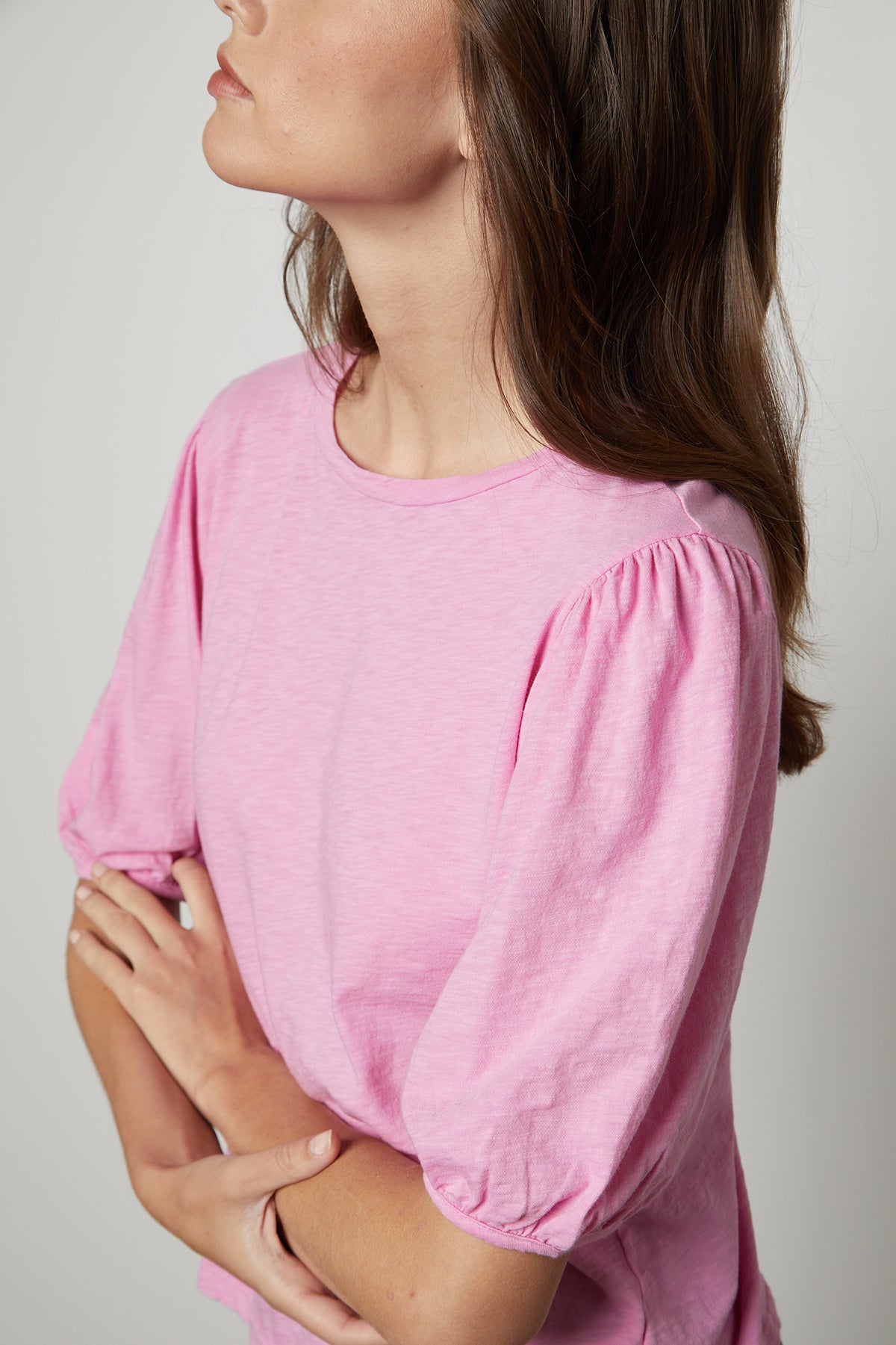 a woman wearing a pink Velvet by Graham & Spencer Joella Puff Sleeve Tee.-25954591342785