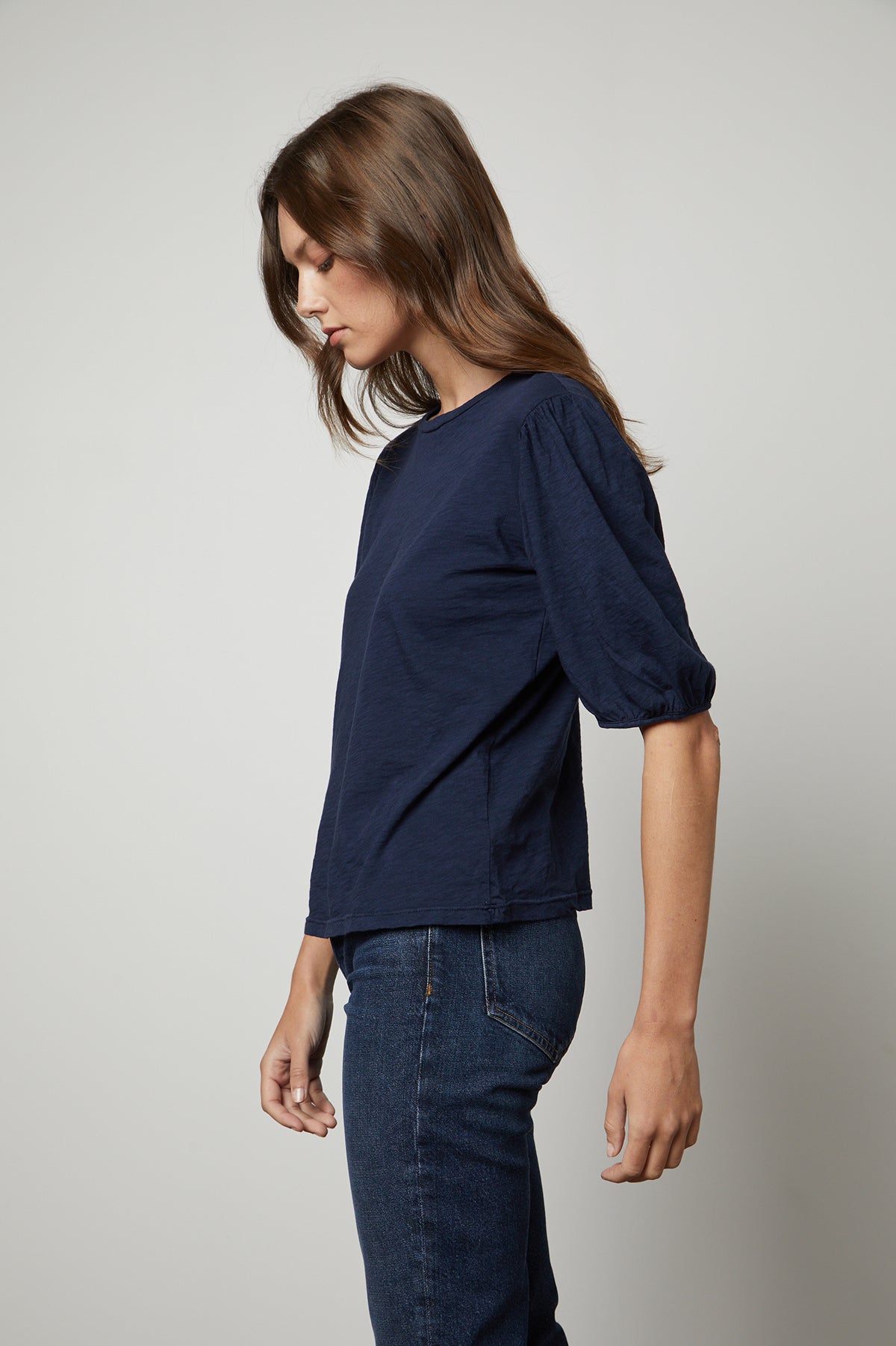  a woman wearing jeans and a Velvet by Graham & Spencer blue Joella puff sleeve tee. 