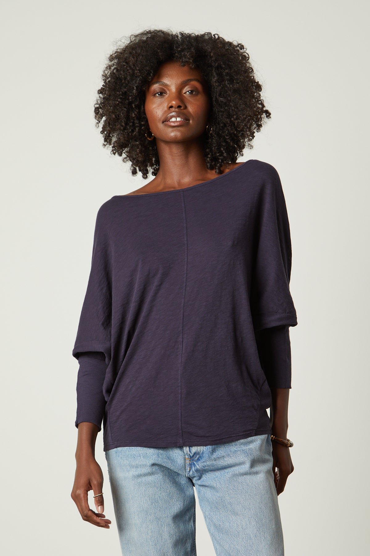   A woman wearing jeans and a Velvet by Graham & Spencer JOSS DOLMAN SLEEVE TEE. 