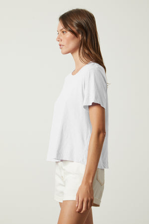 a woman wearing a Velvet by Graham & Spencer LULA COTTON SLUB SWING TEE and white shorts.