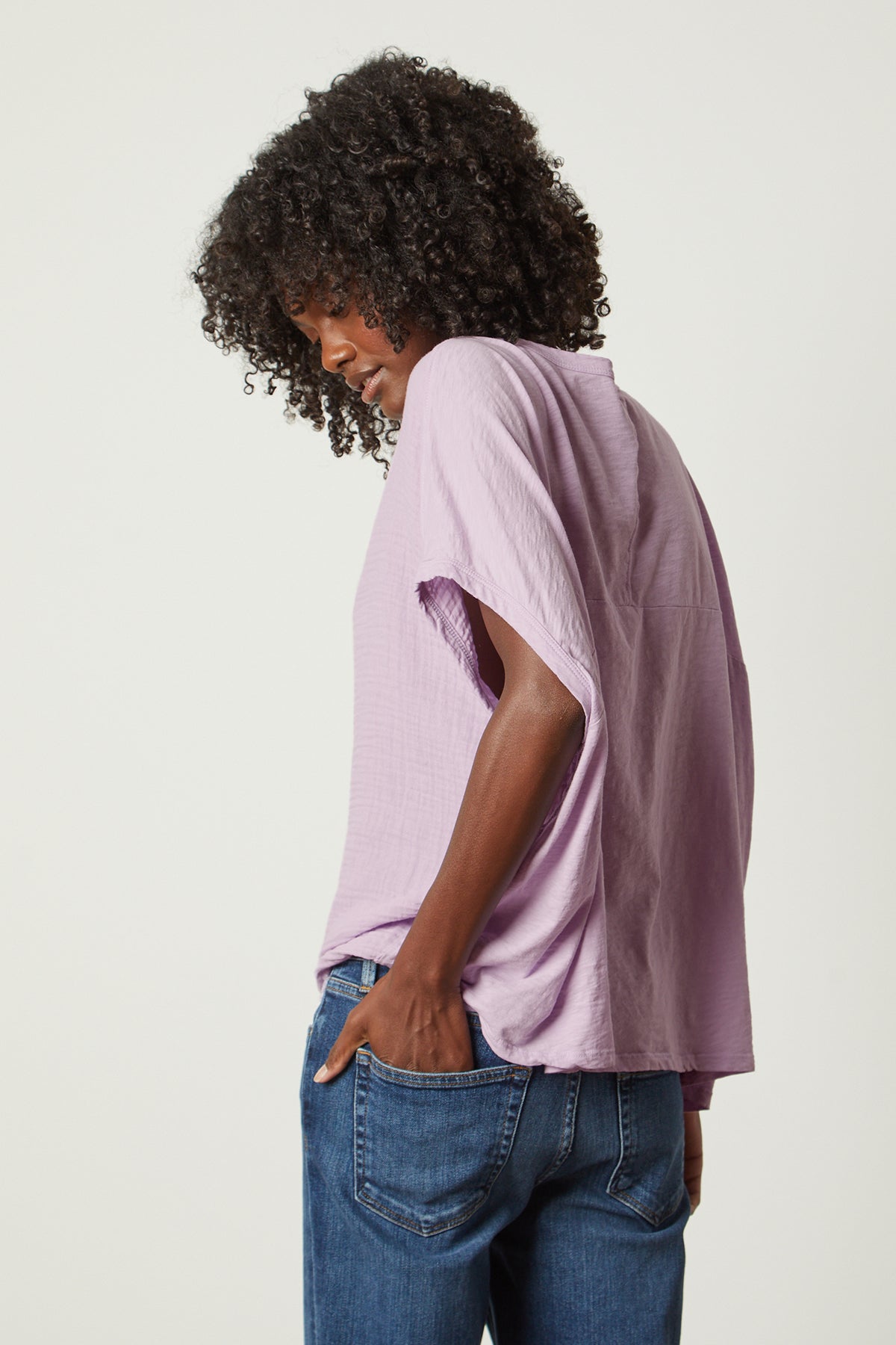   the back view of a woman wearing a Velvet by Graham & Spencer CORA BOXY TEE top and jeans. 