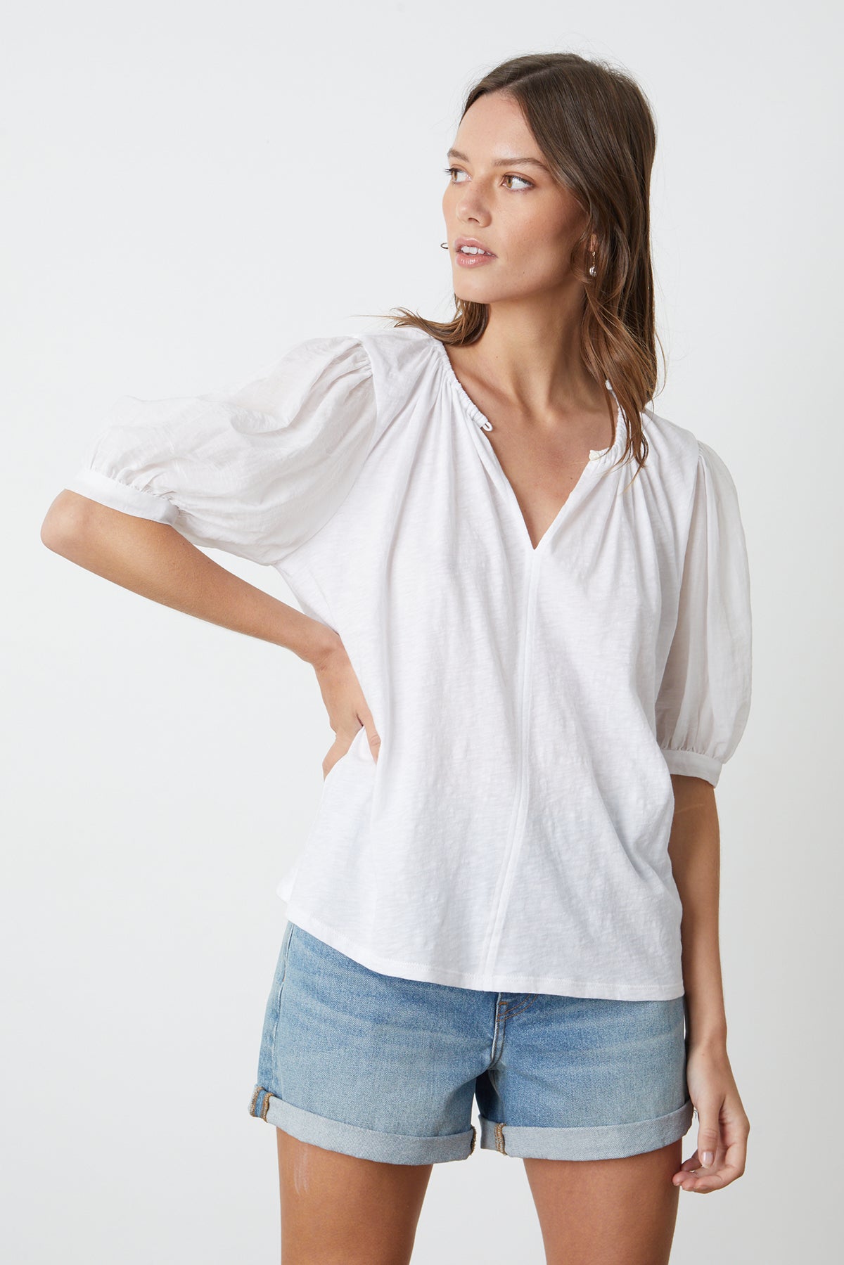   Mallory Top in white with puff sleeves paired with blue denim shorts front 
