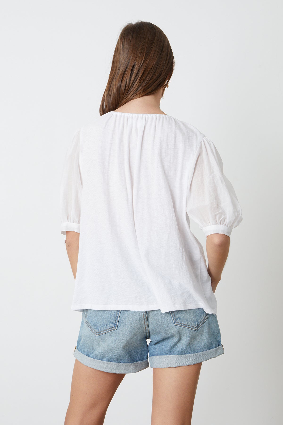   Mallory Top in white with puff sleeves paired with blue denim shorts back 