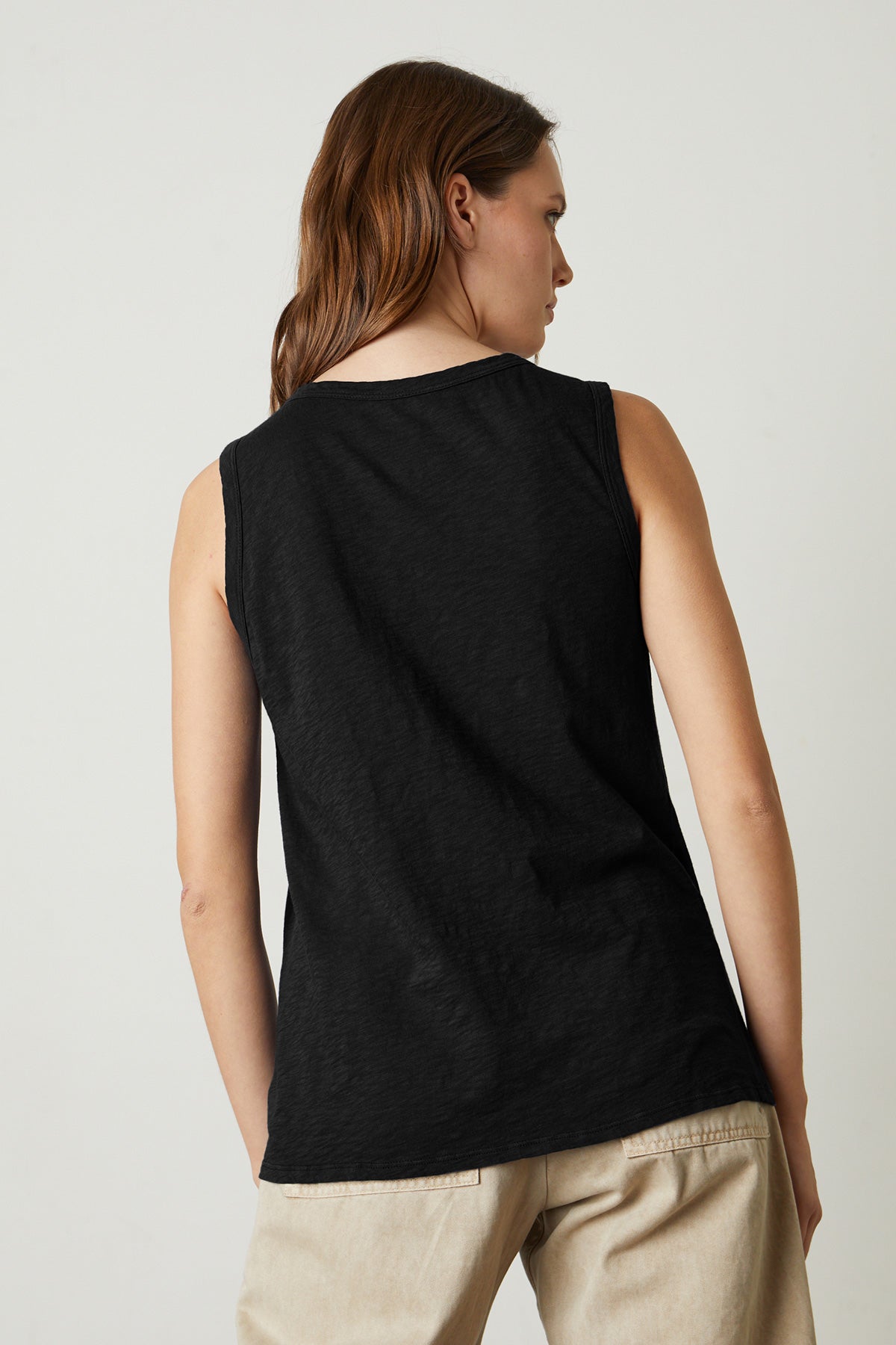 The back view of a woman wearing a TAURUS COTTON SLUB TANK by Velvet by Graham & Spencer.-25046259728577