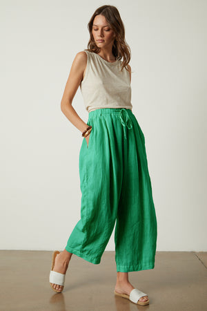 Hannah Linen Pant in jade green with Taurus tank in sand tucked full length front model hand in pocket