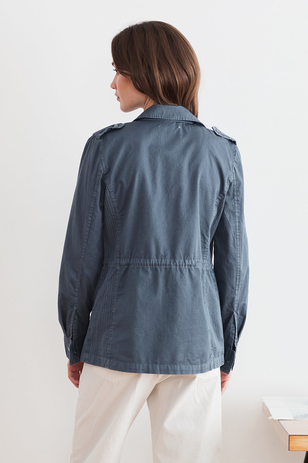 The back view of a woman wearing the Velvet by Graham & Spencer RUBY LIGHT-WEIGHT ARMY JACKET.-7237763760209