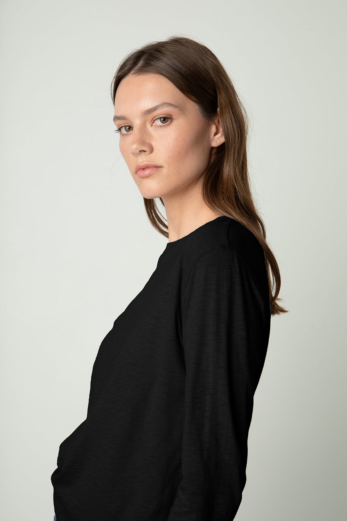 The model is wearing a Velvet by Graham & Spencer HESTER CREW NECK TEE.-24535847338177