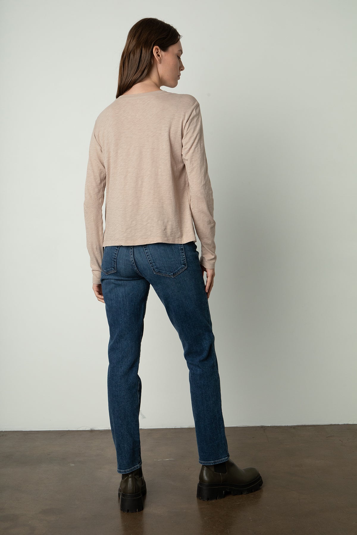   the back view of a woman wearing Velvet by Graham & Spencer jeans and a HESTER CREW NECK TEE. 