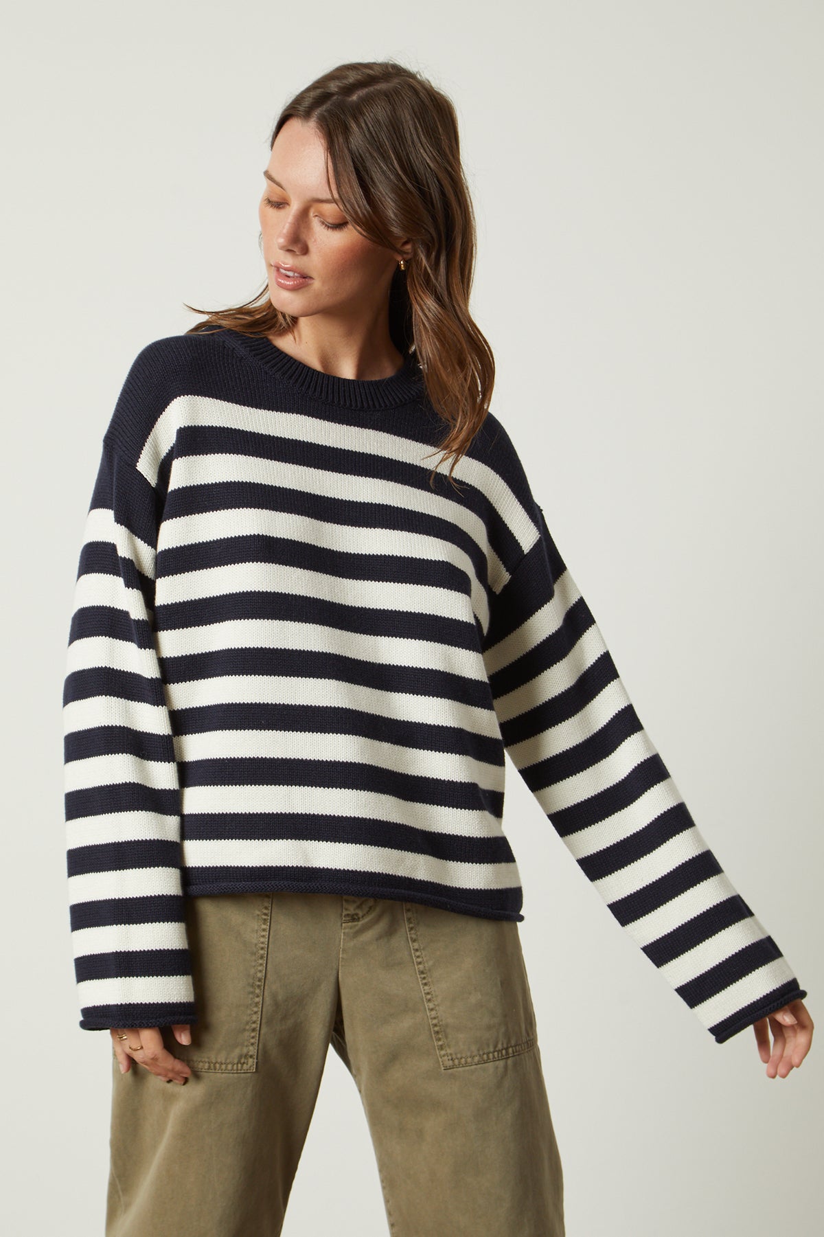 a woman wearing a Velvet by Graham & Spencer LEX STRIPED CREW NECK SWEATER.-25916265758913