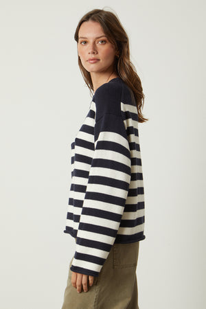 a woman wearing a Velvet by Graham & Spencer LEX STRIPED CREW NECK SWEATER.