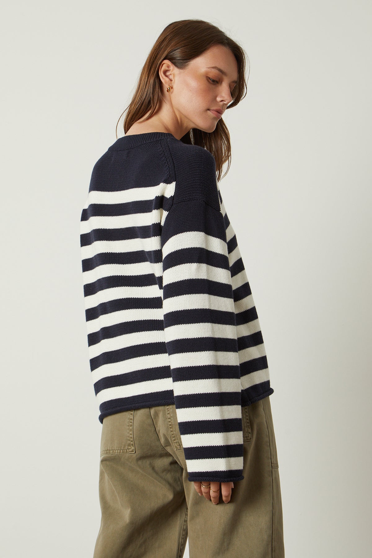 The sentence: "the back view of a woman wearing a navy and white striped sweater" can be replaced with "the back view of a woman wearing the Velvet by Graham & Spencer LEX STRIPED CREW NECK SWEATER.-25916265824449