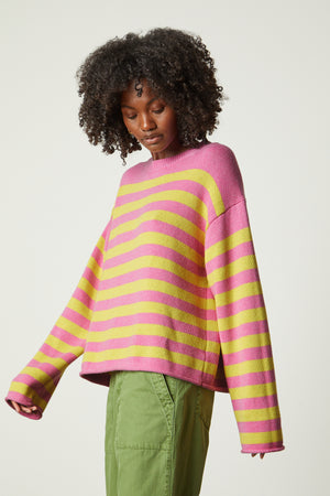a model wearing a Velvet by Graham & Spencer LEX STRIPED CREW NECK SWEATER.