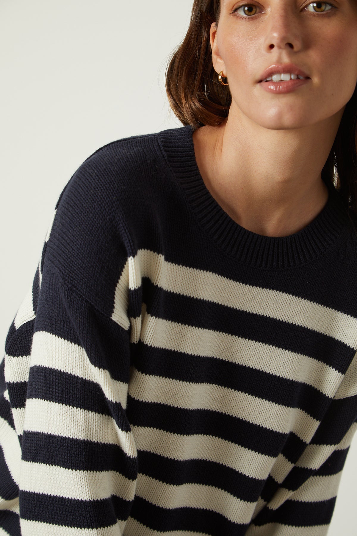 The model is wearing the LEX STRIPED CREW NECK SWEATER by Velvet by Graham & Spencer.-25916265857217