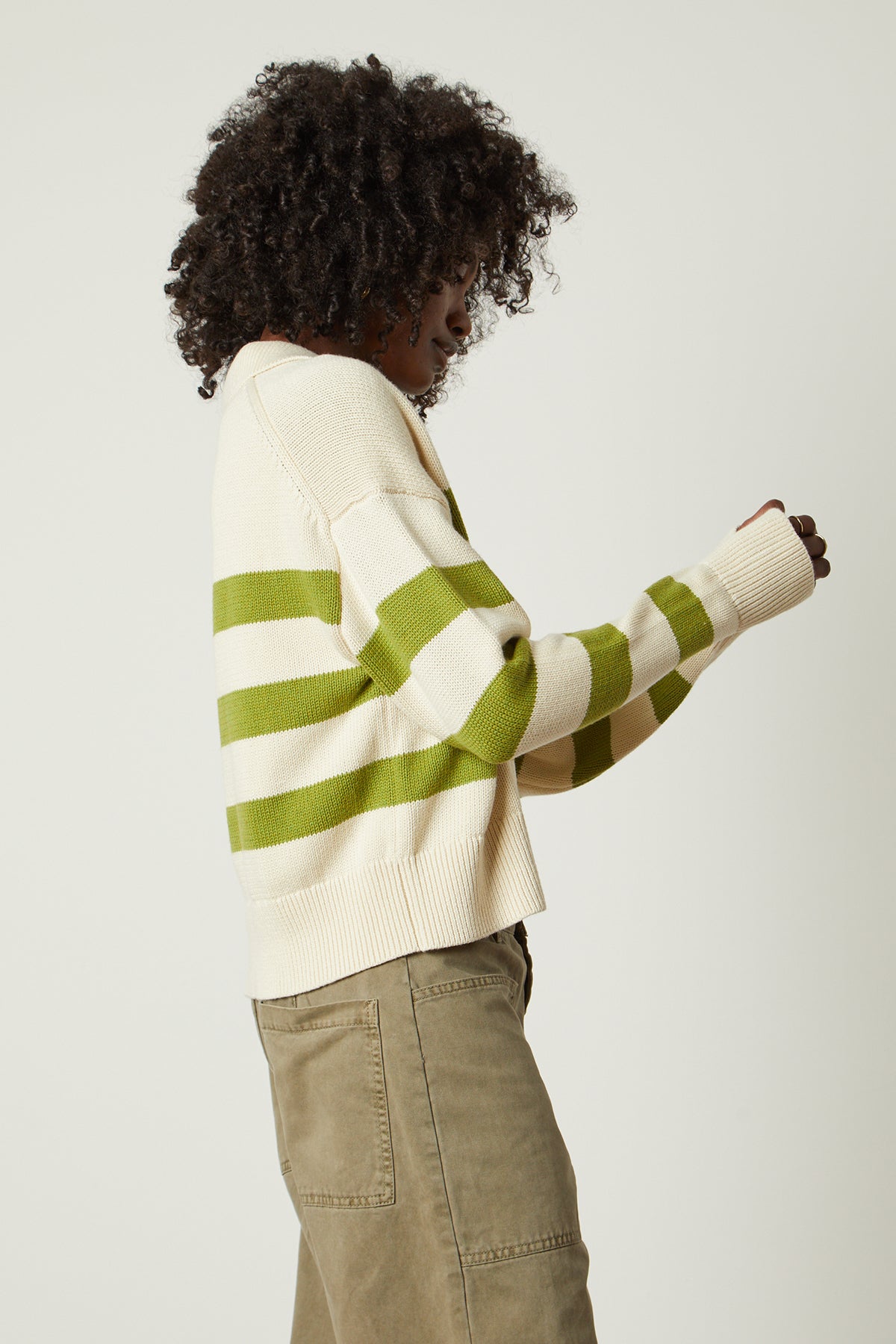   a woman wearing a Velvet by Graham & Spencer LUCIE STRIPED POLO SWEATER. 