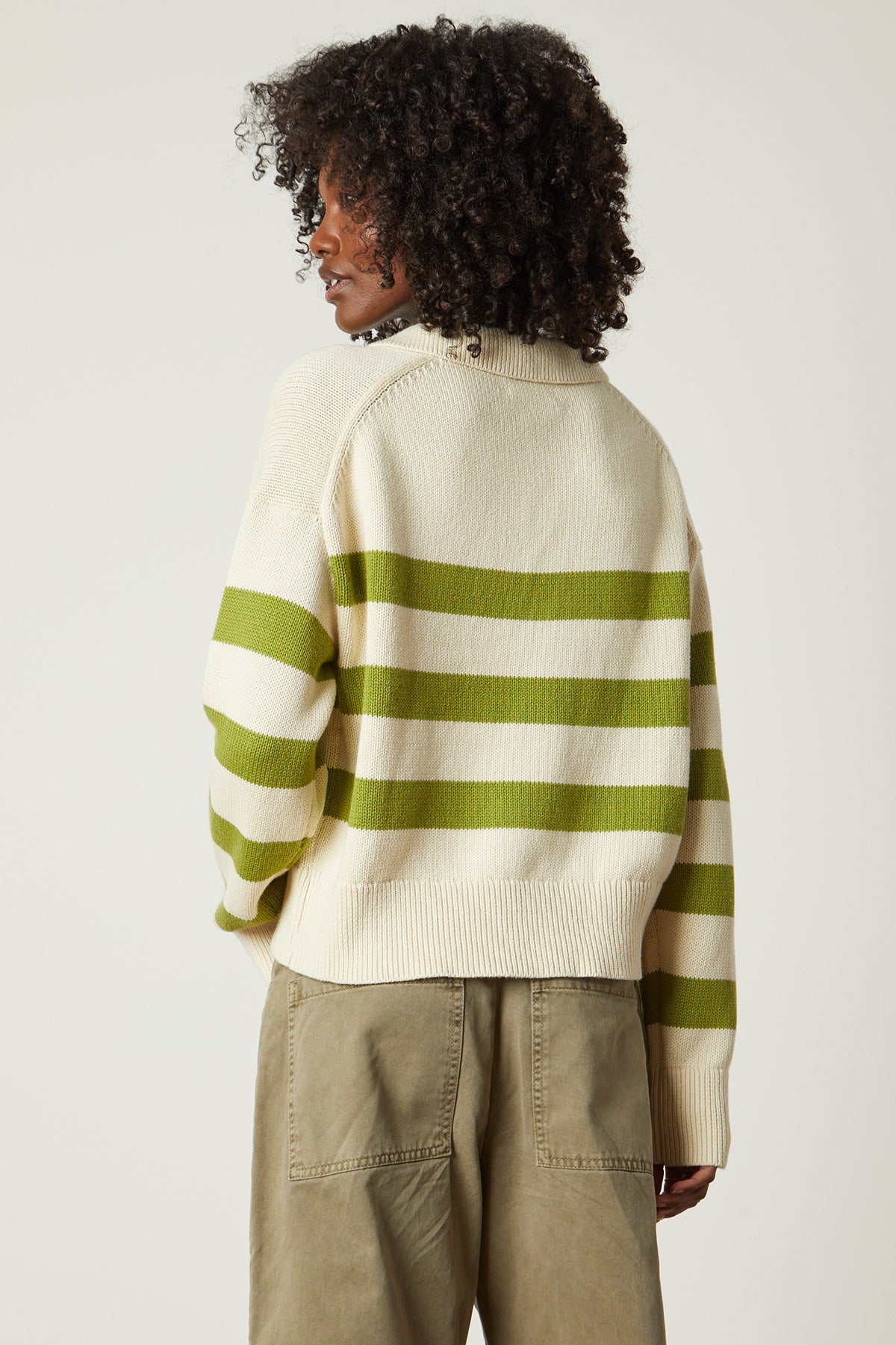   the back view of a woman wearing a Velvet by Graham & Spencer LUCIE STRIPED POLO SWEATER. 