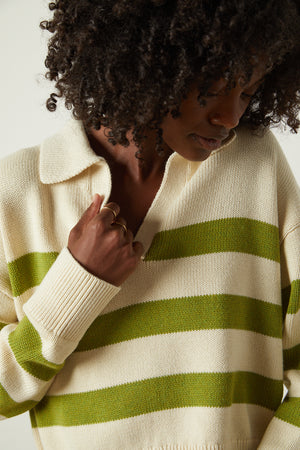 a woman wearing a Velvet by Graham & Spencer LUCIE STRIPED POLO SWEATER.