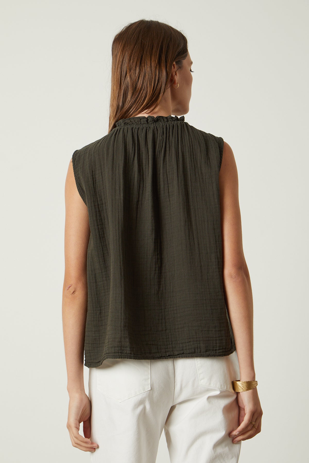 The back view of a woman wearing a Velvet by Graham & Spencer BIANCA COTTON GAUZE TANK TOP and white pants.-26079011012801