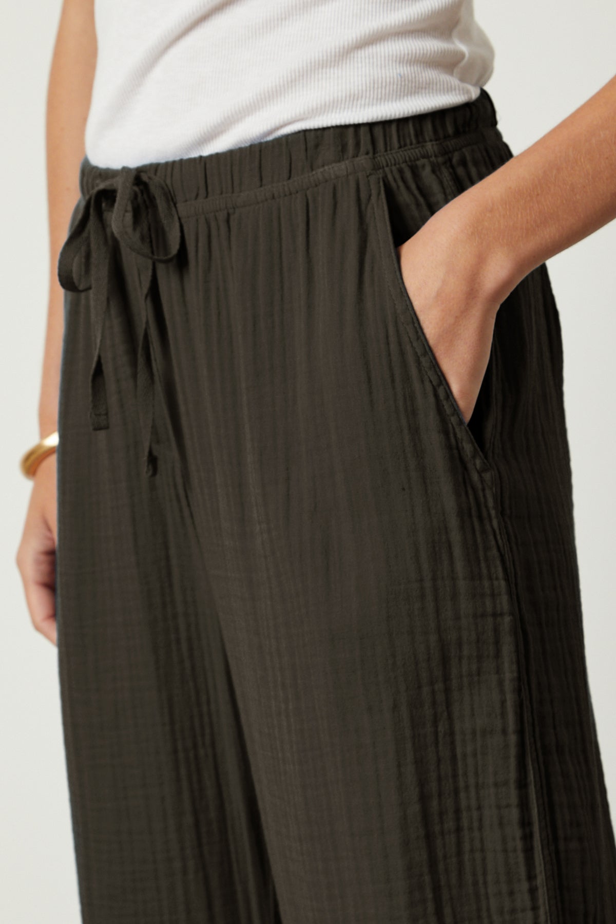 A woman is wearing a pair of Velvet by Graham & Spencer FRANNY COTTON GAUZE PANT wide leg pants front & pocket detail-26143109218497