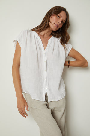 The model is wearing a PAMELA COTTON GAUZE BUTTON-UP TOP by Velvet by Graham & Spencer and tan pants.